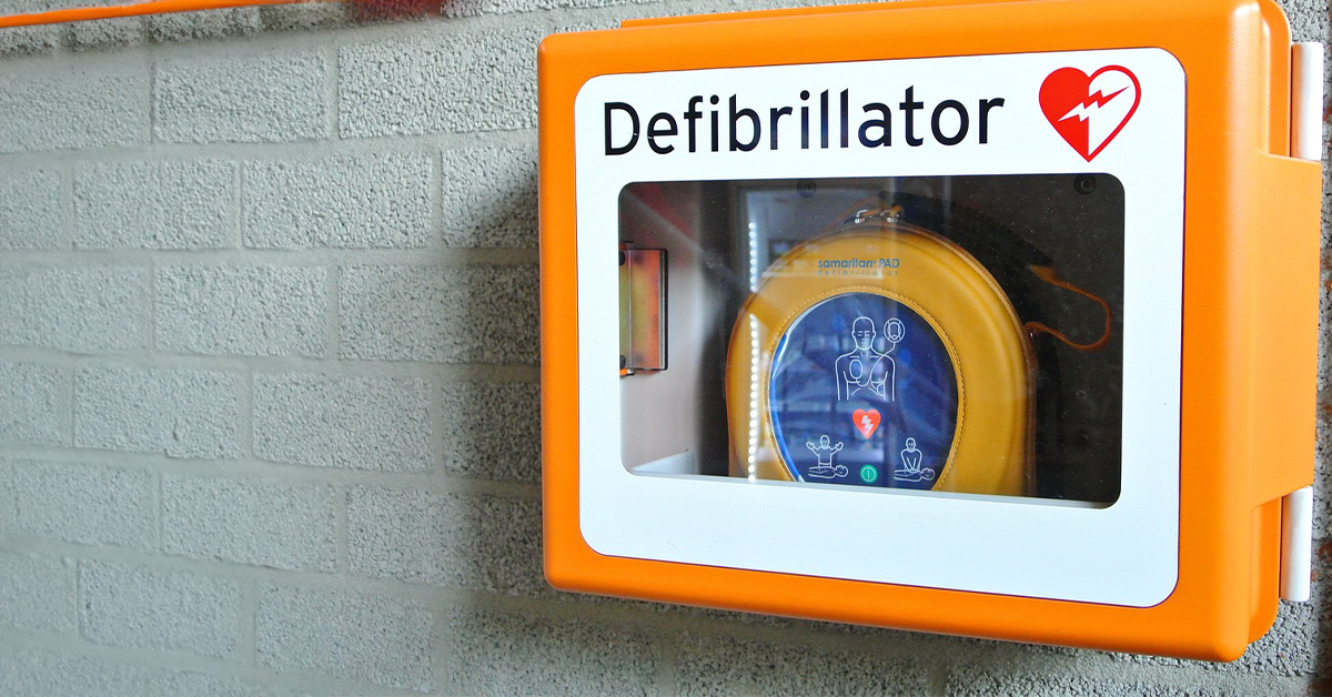 A defibrillator stationed on a wall